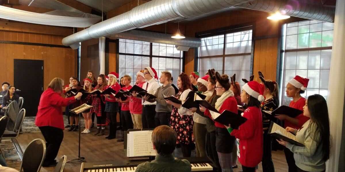 47491903_872919572914615_8056166411619270656_o-w1200(1) - Copy Choir singing